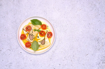 Soft cheese slices with tomatoes