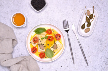 Soft cheese slices with tomatoes