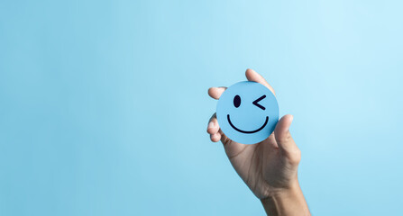 Hands holding blue happy smile face. mental health positive thinking and growth mindset concept.