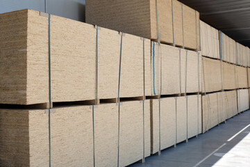 Large outdoor warehouse for wooden plywood sheets of various sizes.