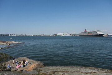 Luxury ocean liner cruiseship cruise ship Victoria or Elizabeth in port of Helsinki, Finland during Baltic cruising with city skyline	