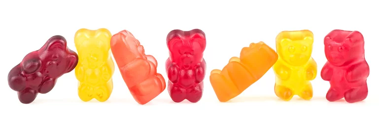 Foto auf Glas Group of colorful jelly gummy bears isolated on a white background. Tasty jelly candies. © domnitsky