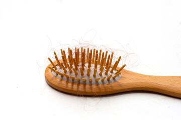 Hairs loss fall in comb on white background.