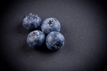 Blueberries on stone plate background