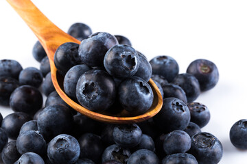 Fresh blueberries in wooden spoon