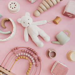 Set of stylish natural Scandinavian baby kids toys on pastel pink background. Baby girl stuff for playing and education. Flat lay, top view