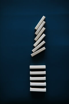 Closeup thick domino wood block in a row stop the falling, be stable in crisis, business solution concept