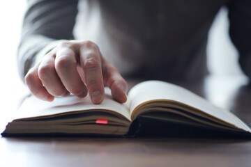 Read book. A man sits and reads literature. Textbooks to study. Religion.