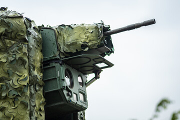Anti-drone laser system trialed on a Stryker combat military vehicle with a machine gun aimed at...