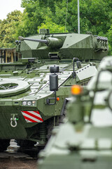 Armoured tanks and military infantry fighting vehicles ready to move under the rain, Lithuanian Land Force, NATO response force