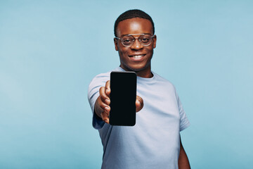 African man holding up his blank phone screen