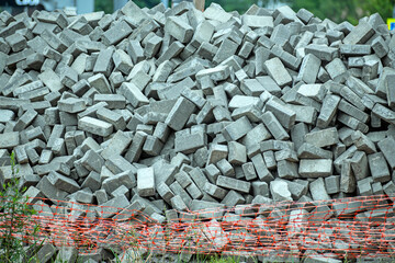The road tiles are stacked in a pile on a summer day