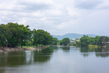 Fototapeta na wymiar Lampang Wang River , beautiful nature landscape of irrigation water canal in Northern Lampang province in Thailand.