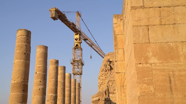 Reconstruction of Hatra Ruins in Iraq, Crane Next to Ancient Monument and Columns Damaged by Isis War, Archaeology Site 