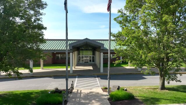 School entrance, low angle aerial. forward push in. Aerial of American elementary school in USA.