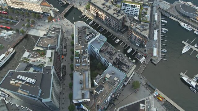 Flying over the rooftops of the buildings of Aker Brygge in Oslo Norway