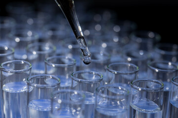 Pipette dropping fluid into test tube