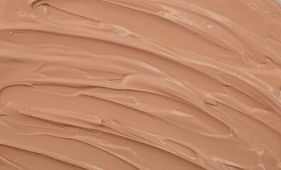 The base of the foundation is smeared as a sample background close-up. Makeup cosmetics. Concealer. Concealer texture.