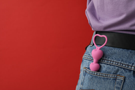 Anal chain in the pocket of jeans on a red background