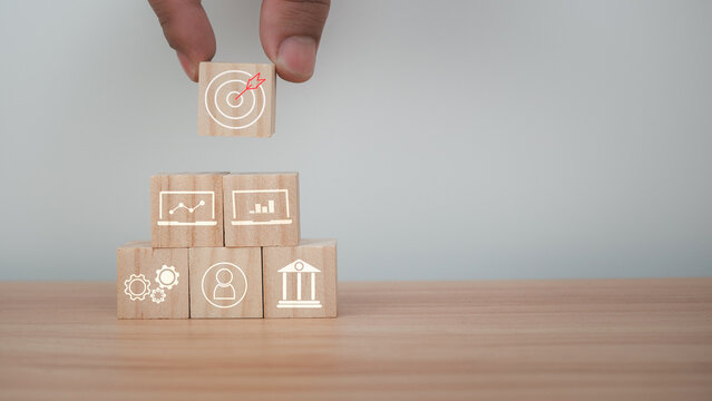 Wood cube block stacking with icon.Concept of business strategy and goal action plan.