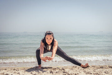 Fototapeta na wymiar Fitness Girl working out on the beach
