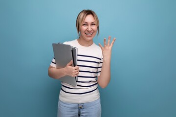 Fototapeta premium horizontal photo of attractive business woman in casual striped sweater with laptop showing four fingers on blue background
