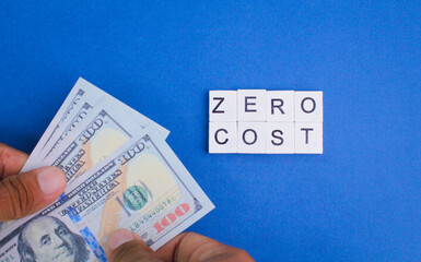 banknotes and letters of the alphabet with the word ZERO COST. business concept. no cost