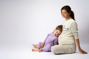 Pregnant mother and daughter are spending time together