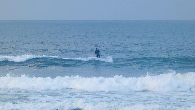 close view of surfer decides to relinquish the opportunity presented by a small wave.