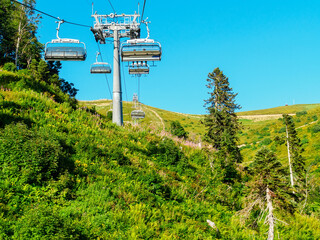 Cable car high in the mountains on a sunny day in summer