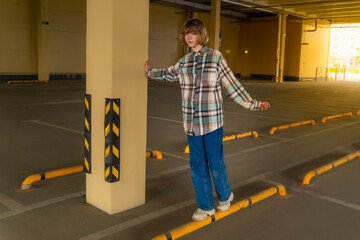 Preteen girl in an empty covered parking lot