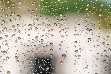 Raindrops on room window glass. Rainy weather in city