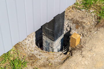 Installation of a new fence. The post is dug into the ground