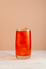 Refreshing cold drink.  Summer fruit lemonade with ice in a tall glass