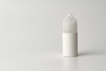 Refill liquid for electronic cigarettes on gray background