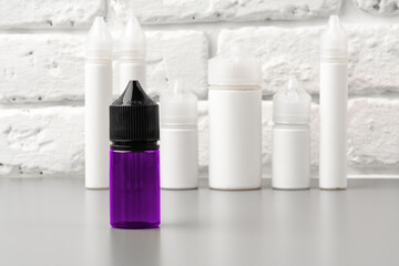Refill liquid for electronic cigarettes against brick wall background