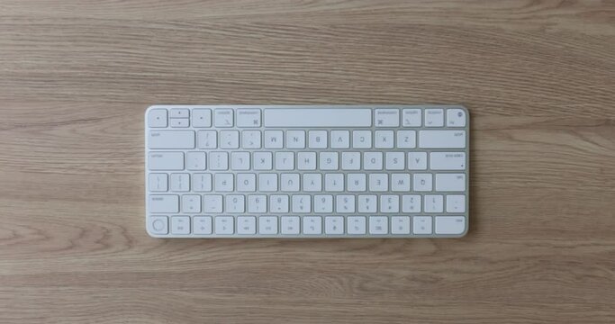Hand and keyboard spacebar on table. Spacebar long horizontal key at bottom of keyboard