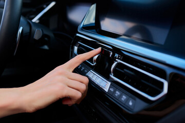 Obraz premium Close-up of a woman's hand pressing the emergency button in the car. Emergency stop. Modern car