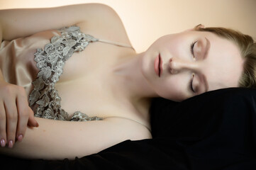 Calm young woman on pillow.