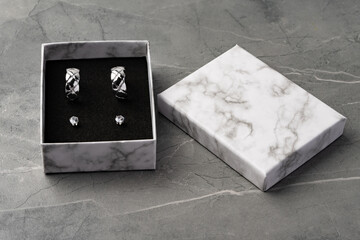 Jewelry box with earrings on a gray background