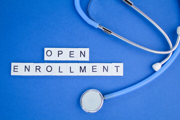 stethoscope and pen with the words Open Enrollment. open enrollment concept. student registration