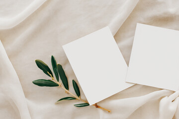 Delicately white silk background, white A4, A6 paper cards, business cards and flyers for a cosmetic company, beauty industry. Soft background, gentle colors. Generative AI