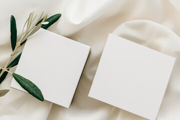 Delicately white silk background, white A4, A6 paper cards, business cards and flyers for a cosmetic company, beauty industry. Soft background, gentle colors. Generative AI
