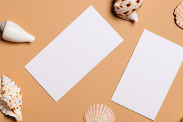 Gently beige background, white paper cards A4, A6, business cards and flyers for the company, beauty industry. Soft background, sea and river shells. Generative AI
