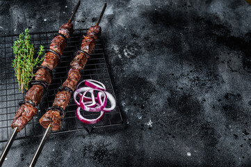 Cooked on the grill beef shish kebab with vegetables and spices, grileld meat. Black background....