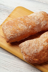Two bread buns on wooden board close up