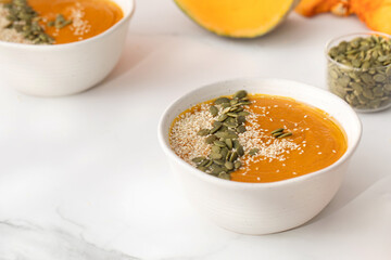 A plate with pumpkin soup puree, pumpkin and sesame seeds. Autumn menu. 