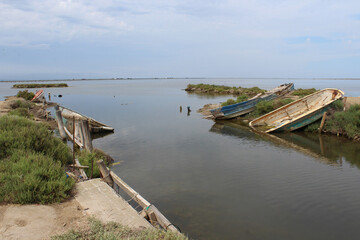 Fototapeta na wymiar Boats cemetery at Delta de l'Ebre. Abandoned old wooden boats.