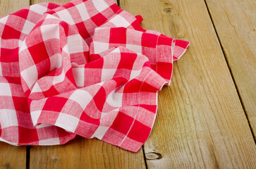 red-white checkered tablecloth in an old wooden table