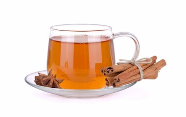 Glass cup of green tea with cinnamon sticks  isolated on white